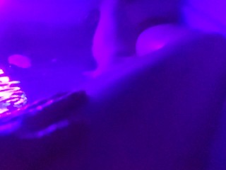 Washing her cheeks in the tub with a blacklight