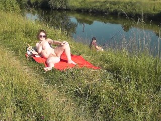 'Riverside nude cougar sunbathing is not bashful about random fisher. Outdoors. Horny beach. Public nudity'