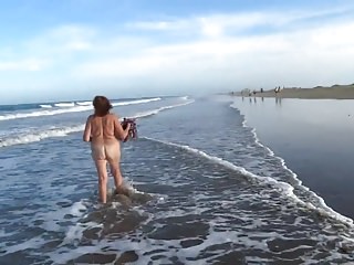 Mature woman posing on the beach and the dunes