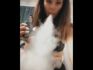 Vaping in brassiere and stretch pants